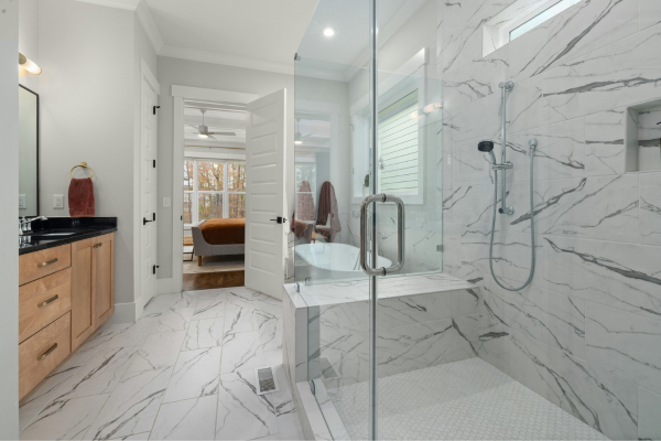 Bathroom with marble-look wall tiles and glass shower